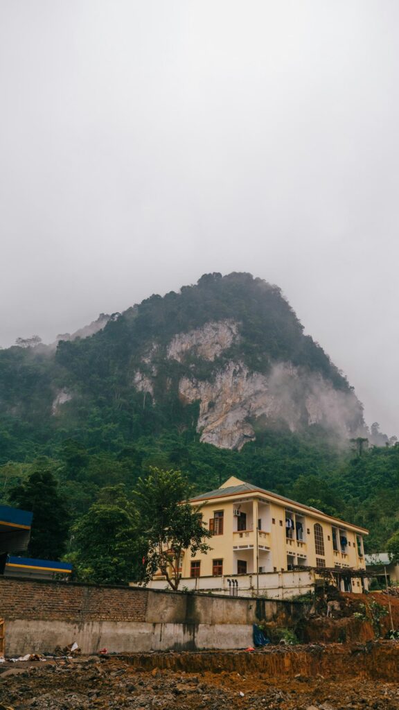 Misty Limestone Mountain and Colonial Villa Architecture Wallpaper
