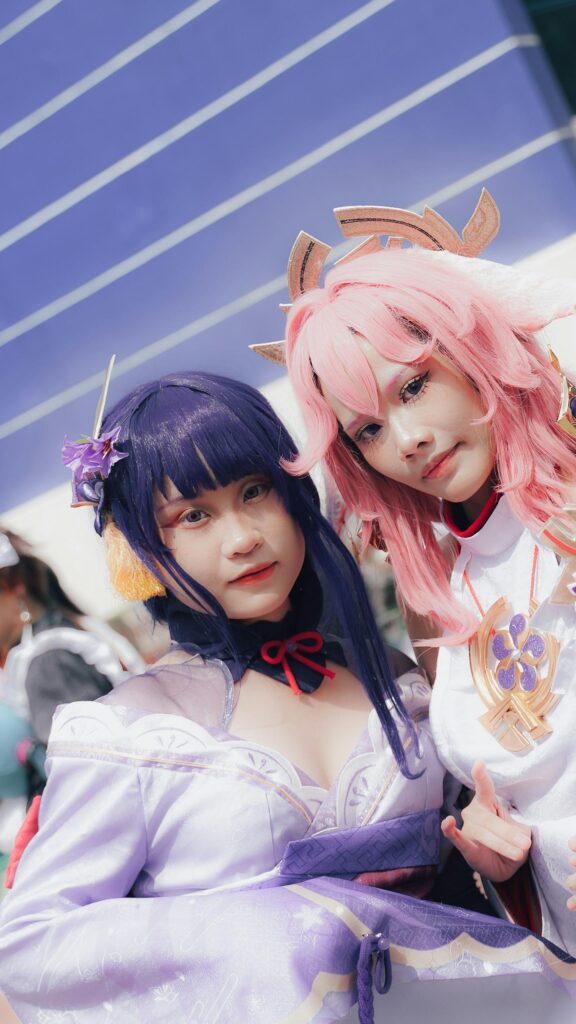 Stunning Raiden Shogun and Yae Miko Genshin Impact Cosplay Wallpaper