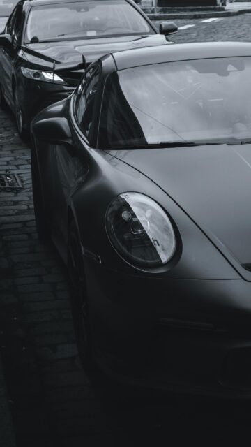 Sleek Matte Black Porsche 911 Sports Car Phone Wallpaper