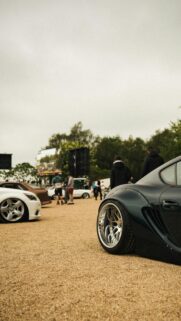 Stanced Widebody Sports Car at Outdoor Automotive Show Wallpaper