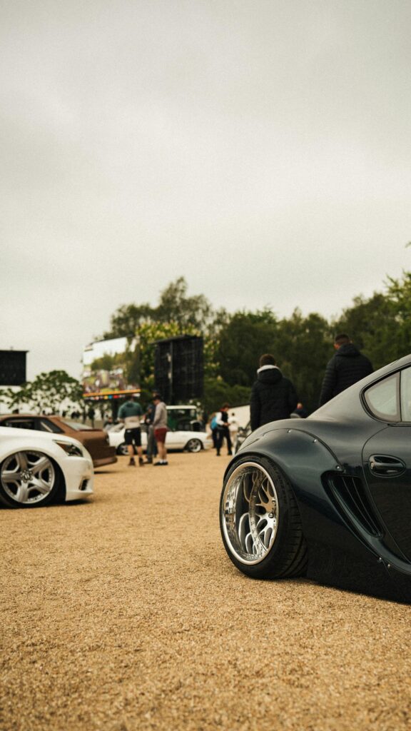Stanced Widebody Sports Car at Outdoor Automotive Show Wallpaper