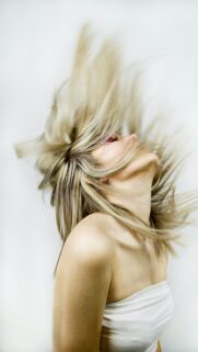 Dynamic Blonde Woman Hair Flip Artistic Studio Portrait Mobile Wallpaper