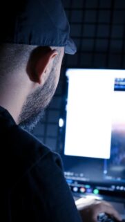 Creative Video Editor at Work in Dark Studio Mobile Wallpaper