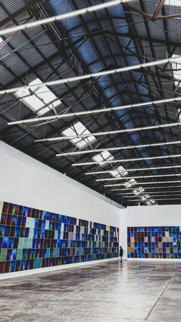 Minimalist Art Gallery Interior with Colorful Grid Artwork Wallpaper