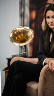 Elegant Woman in Suit with Vintage Gramophone Mobile Wallpaper