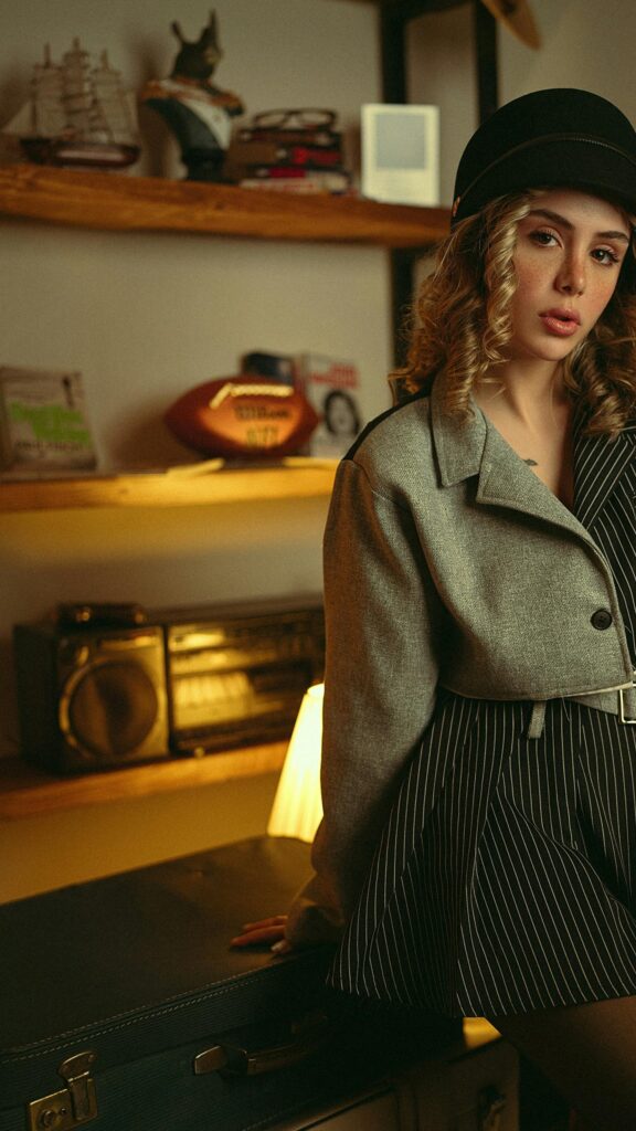 Stylish Girl in Vintage Fedora and Blazer Mobile Background Wallpaper