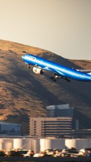 ITA Airways Plane Taking Off Over Mountains Phone Wallpaper