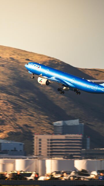 ITA Airways Plane Taking Off Over Mountains Phone Wallpaper