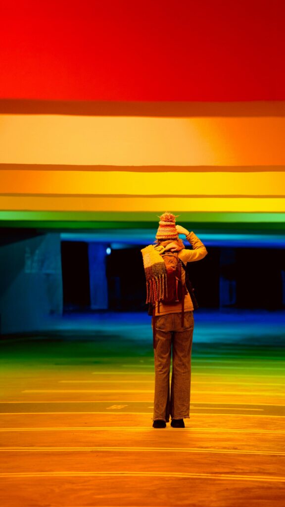 Person Standing in Rainbow Light Tunnel Aesthetic Mobile Wallpaper
