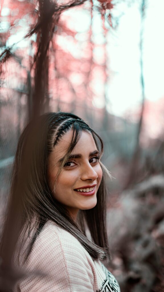 Beautiful Woman with Braided Hairstyle Looking Back Phone Wallpaper