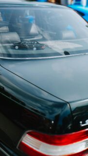 Minimalist Black Lexus Sedan with Miniature Car Rear Shelf Wallpaper