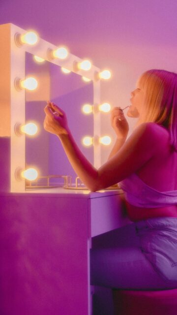 Aesthetic Neon Glow Beauty Routine Girl Vanity Mirror Wallpaper