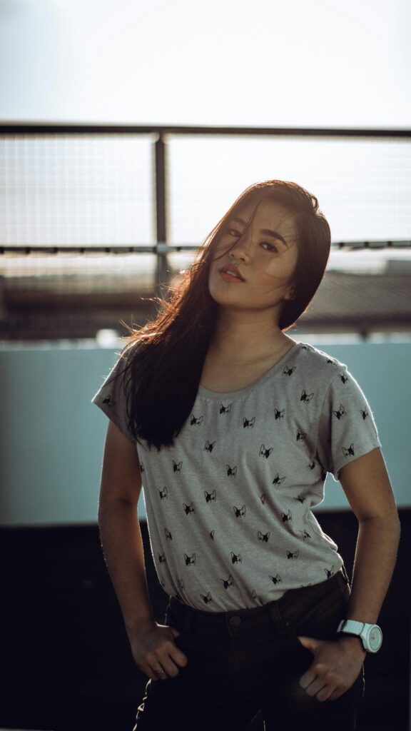 Beautiful Asian Girl with Backlit Hair on Rooftop Portrait Wallpaper