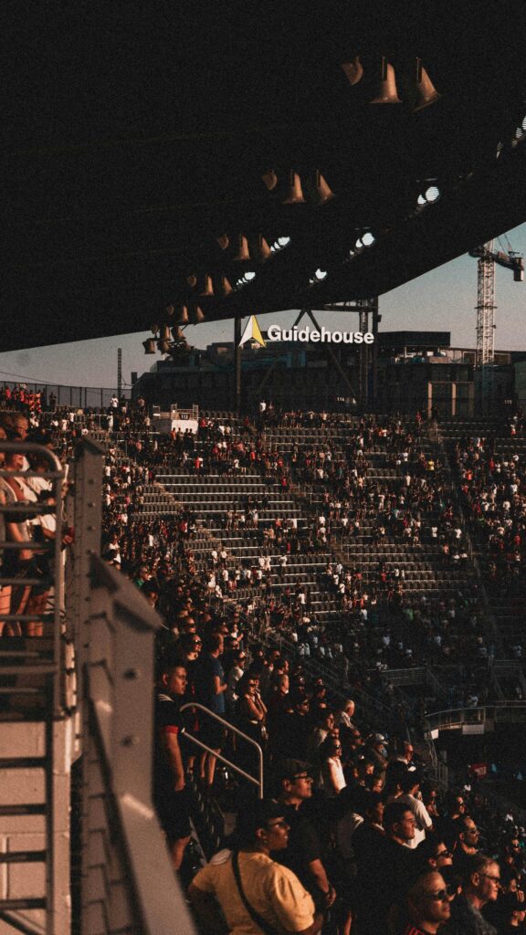 Stadium Crowd Atmosphere at Sunset Mobile Phone Wallpaper