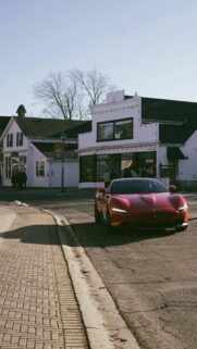 Stunning Red Ferrari Roma Sports Car on Historic Street Wallpaper