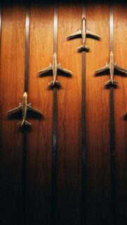 Elegant Brass Airplane Model Wall Art Wood Texture Mobile Wallpaper