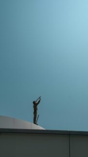 Minimalist Golden Statue Looking Up at Clear Blue Sky Mobile Wallpaper