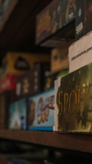Macro Shelf of Board Game Boxes Cinematic Artistic Phone Wallpaper