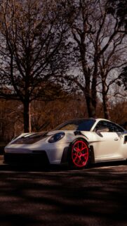 White Porsche 911 GT3 RS with Vibrant Red Wheels Luxury Car Wallpaper