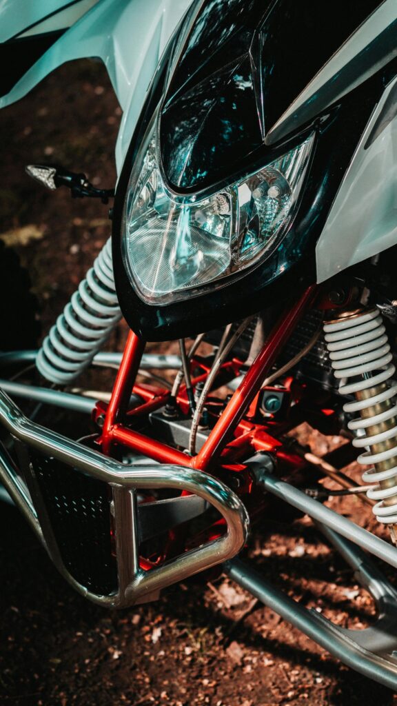Extreme Red and White All-Terrain Racing ATV Front View Mobile Wallpaper