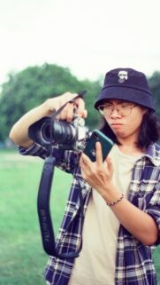 Creative Photographer in Bucket Hat with Camera Mobile Wallpaper