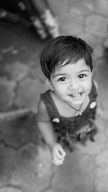 Adorable Smiling Baby Girl Portrait in Black and White Mobile Wallpaper