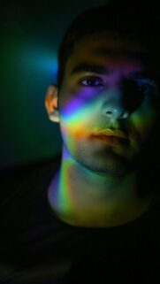 Stunning Artistic Portrait with Vibrant Rainbow Light Effects Mobile Wallpaper