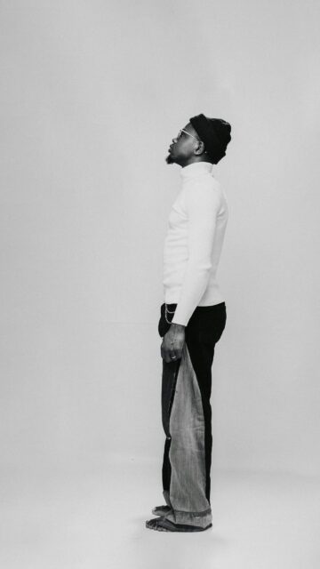 Minimalist Fashion Portrait of Man in White Turtleneck Wallpaper
