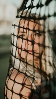 Stunning Blonde Woman Behind Sport Net Artistic Portrait Mobile Wallpaper