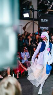 Streetwear Fashion Runaway Model with Blue Vest Mobile Wallpaper
