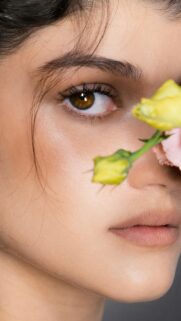 Stunning Portrait of a Woman with Soft Flowers Mobile Wallpaper