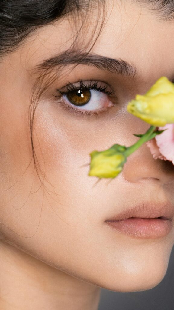 Stunning Portrait of a Woman with Soft Flowers Mobile Wallpaper