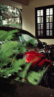 Red Triumph Street Triple RS Motorcycle Parked Near Car Wallpaper