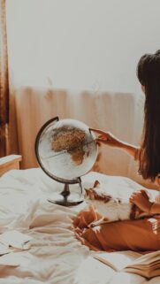 Dreamy Traveler Girl with Cat and World Globe Aesthetic Wallpaper
