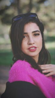 Stunning Young Woman in Pink Fuzzy Sweater Portrait Mobile Wallpaper