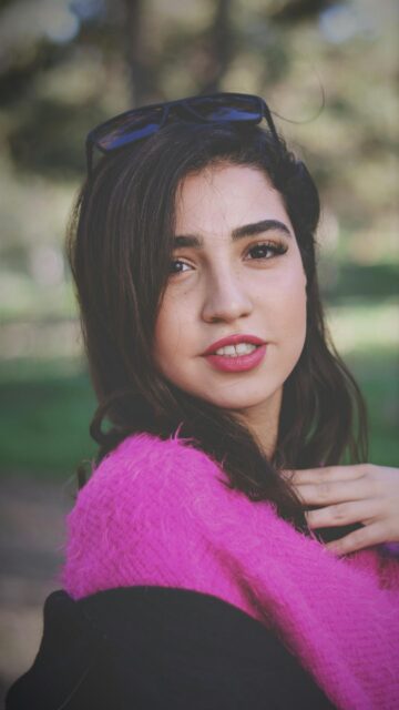 Stunning Young Woman in Pink Fuzzy Sweater Portrait Mobile Wallpaper