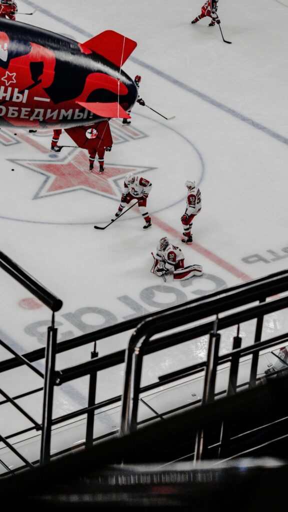 Professional Hockey Goalie and Players on Ice Arena Wallpaper