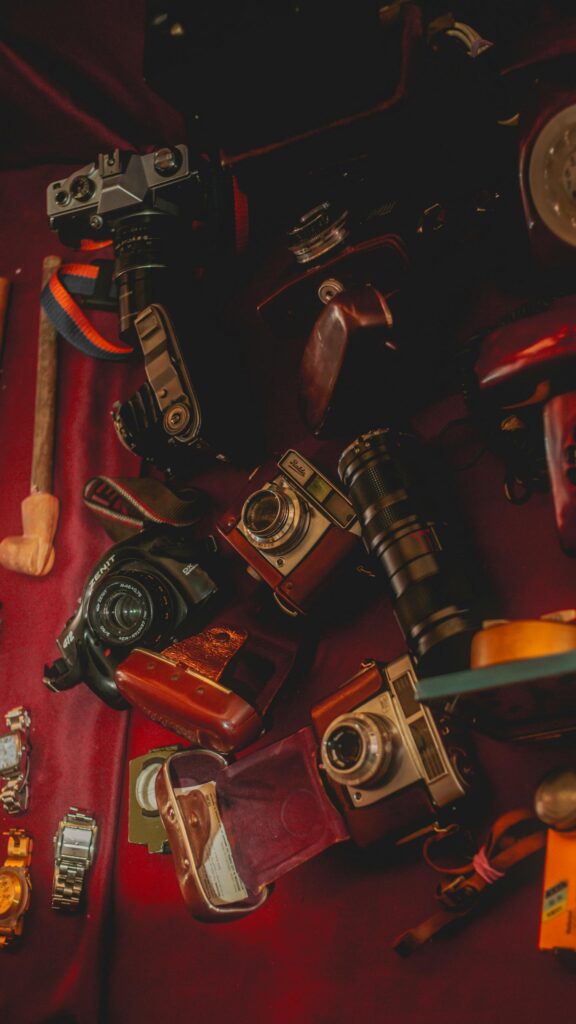 Vintage Camera Collection on Deep Red Fabric Mobile Wallpaper