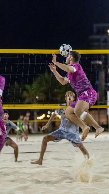 Action Beach Volleyball Player Jumping at Net High Resolution Wallpaper
