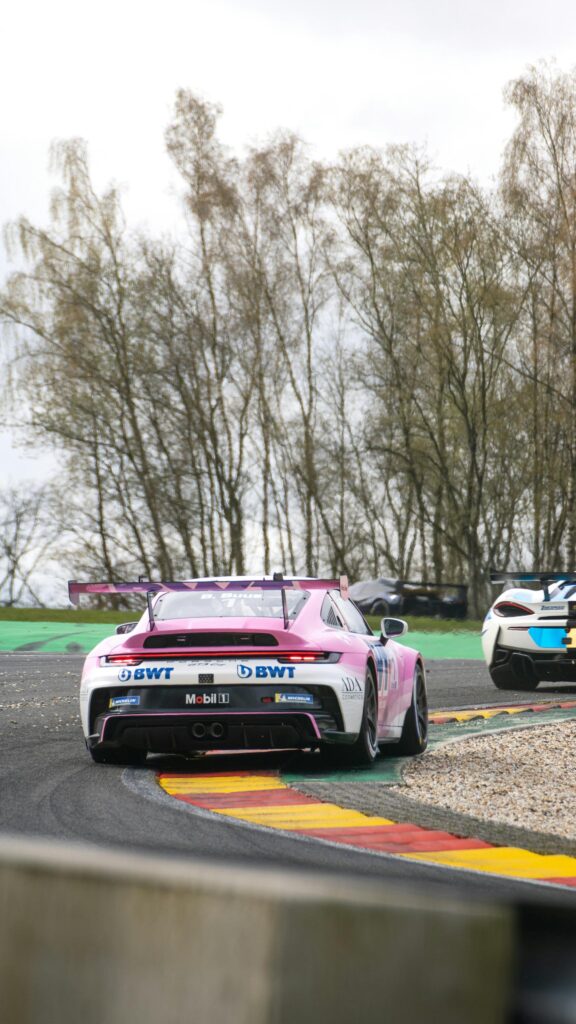 Pink BWT Porsche 911 GT3 Cup Car on Racetrack Mobile Wallpaper
