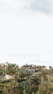 Mediterranean Resort Villa Amidst Lush Tropical Palm Trees Wallpaper
