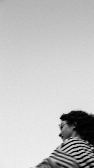 Moody Motion Blur Girl in Striped Shirt Minimalist Phone Wallpaper