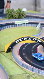 Blue Racing Car Under Dunlop Bridge Slot Car Track Wallpaper