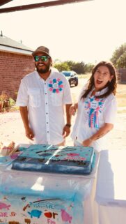 Joyful Gender Reveal Party Couple With Fish Themed Cake Wallpaper