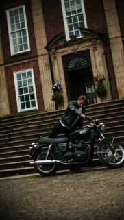 Rugged Biker and Vintage Triumph Motorcycle Elegant Mansion Wallpaper