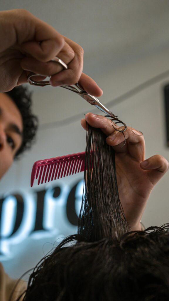 Close-up Professional Barber Cutting Hair for Stylish Mobile Wallpaper
