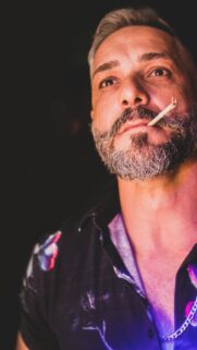 Stylish Man with Salt and Pepper Beard and Toothpick Mobile Wallpaper