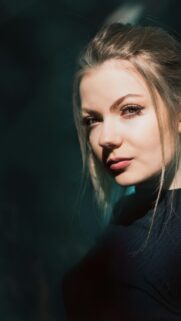 Beautiful Young Woman Portrait with Dramatic Light Mobile Wallpaper