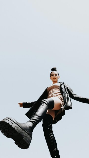 Stylish Woman in Leather Boots Low Angle Fashion Portrait Wallpaper