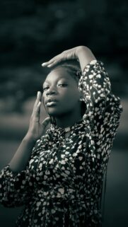 Elegant Young Black Woman in Floral Print Portrait Mobile Wallpaper